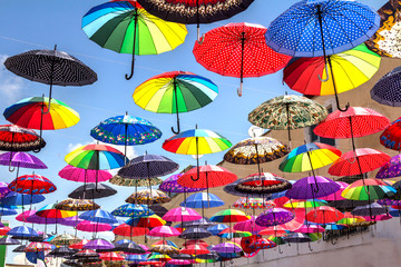 colorful umbrella roof between buildings in a shopping center