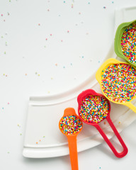 Colourful Sugar sprinkles, decoration for cake, ice-cream and cookies. Top view, Flat lay on white background. Copy space.