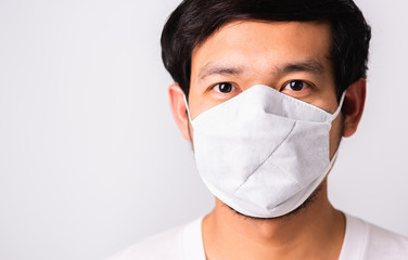 Man wearing surgical hygienic protective cloth face mask against coronavirus