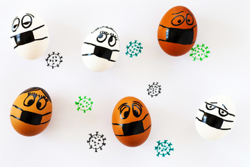 Eggs with painted faces and medical masks