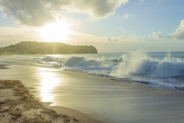 waves crashing beach during a beautiful sunset