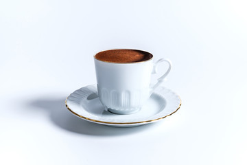 A cup of Turkish coffee in traditional white porcelain Turkish coffee cup