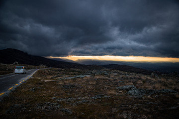 car walking on the mountain with storm