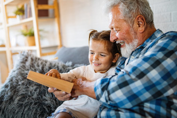Grandparents playing and having fun with their granddaughter