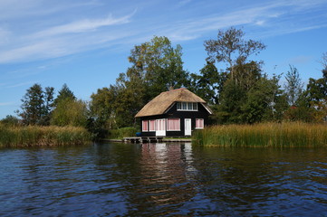 Obraz premium Nice rural house with a small garden near the river