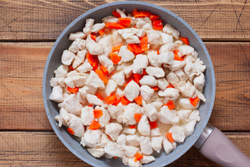 Step-by-step preparation of chicken fillet with mushrooms in sour cream sauce, step 5 - adding...