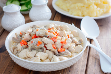 Chicken fillet with mushrooms in sour cream sauce, selective focus
