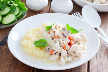 Chicken fillet with mushrooms in sour cream sauce, selective focus