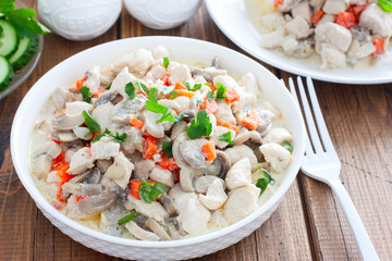 Chicken fillet with mushrooms in sour cream sauce, selective focus