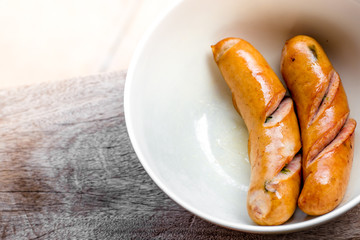 background of the delicious sausages, which are fried or grilled and put on a plate for sale to customers