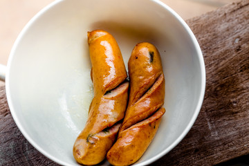 background of the delicious sausages, which are fried or grilled and put on a plate for sale to customers