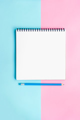 Office supplies on a pink and blue background. Work at home.