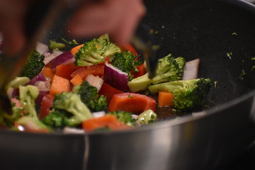 A close up of broccoli cooking in a frying pan