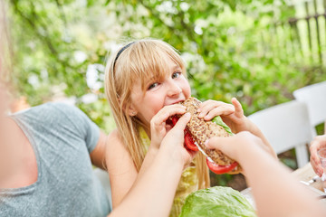 Girl bites hungry in a delicious baguette