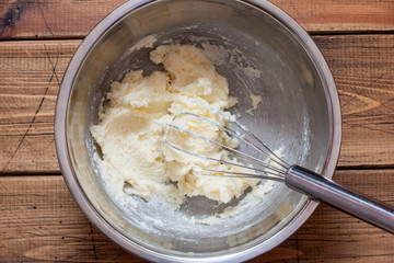 Step by step preparation of vanilla muffins, step 2 - mixing butter and sugar, top view, horizontal