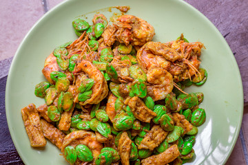 blurred background view of the spicy southern Thai food(stir-fried spicy Sato with fresh prawns),which has a mixture of colorful spices catching the customers, a popular menu eaten with steamed rice