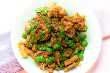 blurred background view of the spicy southern Thai food(stir-fried spicy Sato with fresh prawns),which has a mixture of colorful spices catching the customers, a popular menu eaten with steamed rice
