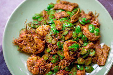 blurred background view of the spicy southern Thai food(stir-fried spicy Sato with fresh prawns),which has a mixture of colorful spices catching the customers, a popular menu eaten with steamed rice