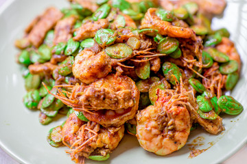 blurred background view of the spicy southern Thai food(stir-fried spicy Sato with fresh prawns),which has a mixture of colorful spices catching the customers, a popular menu eaten with steamed rice