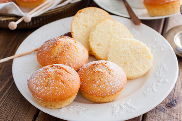 Homemade vanilla muffins sprinkled with icing sugar, selective focus