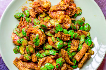 blurred background view of the spicy southern Thai food(stir-fried spicy Sato with fresh prawns),which has a mixture of colorful spices catching the customers, a popular menu eaten with steamed rice