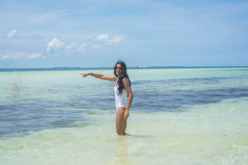 Young indian woman pointing sea in the beach