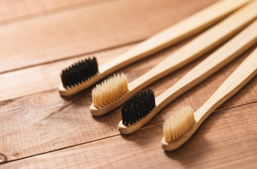 Bamboo toothbrushes on the wooden surface