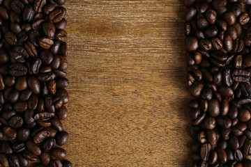 Coffee beans on wooden table with copyspace for text. Selective focus.