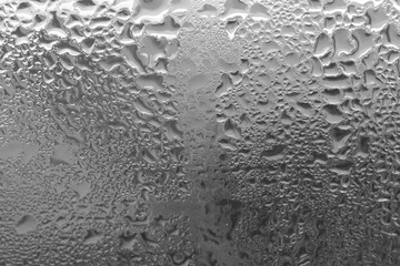Monochrome drops of water. Raindrops close up. Raindrops on the glass.