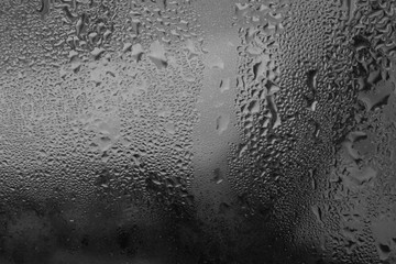 Monochrome drops of water. Raindrops close up. Raindrops on the glass.