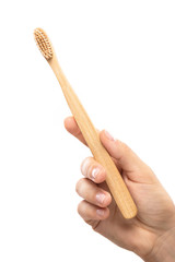 Female hand with a eco-friendly bamboo toothbrush