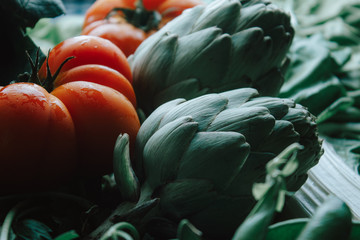 Fototapeta na wymiar Tomato beef heart over artichokes, chard and fennel.