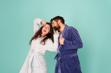 Family life. Happy family blue background. Family of husband and wife have fun. Bearded man and sexy woman in bathrobes. Couple in love blue background. Family values. Mutual love and trust