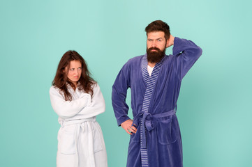 Divorce. Unhappy couple in love blue background. Sexy woman and bearded man in home clothing. Conflict between wife and husband. Family conflict. Relationship conflict. Conflict and conflicting