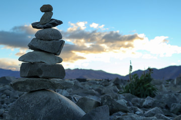 Close up of a cairn against a sunset background