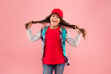Her own hairdresser. Happy girl hold long hair pink background. Kids hairdresser. Hairdresser salon for children. Beauty shop. Style hair with hairdresser. Treat yourself to great service