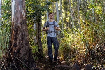 Naklejka na ściany i meble young man is hiking in the beautiful asiatic jungle
