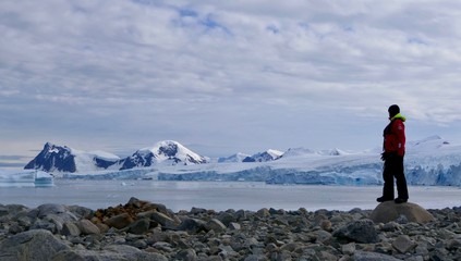 Explorer before glacier on antarctic Island, Antarctica, Stonington Island