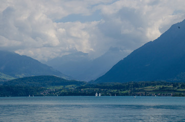 Fototapeta na wymiar Mountain lake against the backdrop of the Alpine mountains