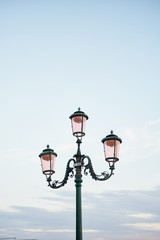 Vintage Venetian street lamp on sky