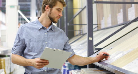 Manager use his tablet for online checking products available.