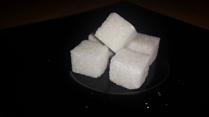 sugar cubes on black background