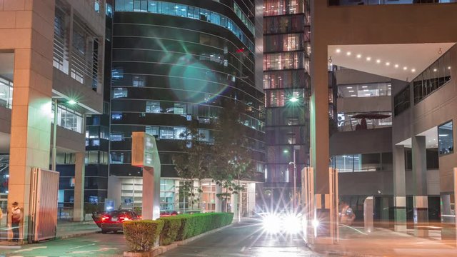 Night cityscape in business area with illuminated skyscrapers timelapse. San Isidro district Lima, Peru. Traffic on the street and glowing windows in offices