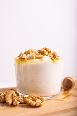 White yogurt cup with honey and nuts. Idea for a healthy and nutritious snack, low in fat.