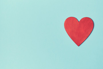 Red heart mockup on blue background, copy space. Blank love symbol for creative design. Happy Valentines Day concept