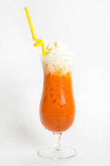 orange thai milk tea with ice top with wipe cream serve in tall glass and straw