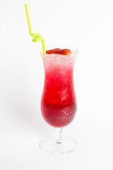 red strawberry juice in a tall glass top with sliced strawberry and straw white background