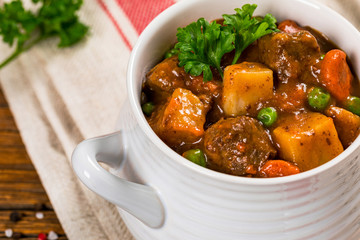 Beef Stew with Potatoes and Carrots made in a Slow Cooker. Selective focus.