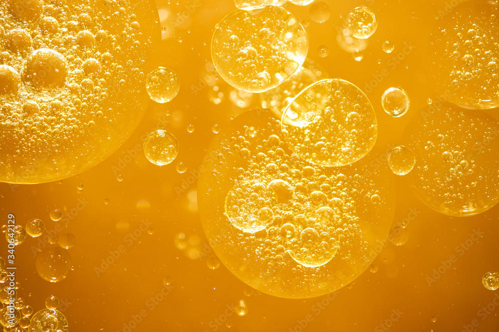 Wall mural golden yellow bubble oil droplet, abstract background