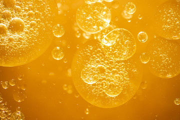golden yellow bubble oil droplet, abstract background - obrazy, fototapety, plakaty